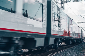 Modern high-speed train moves fast along the platform