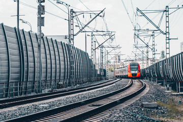 Modern high-speed train moves fast along the platform
