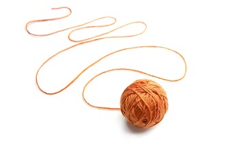 Orange thread ball with serpentine thread isolated on white background. Cotton thread ball. 