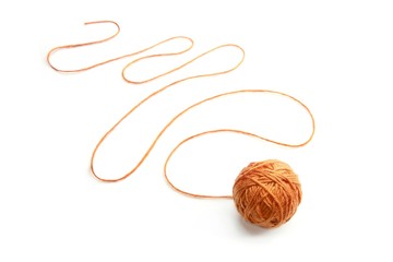 Orange thread ball with serpentine thread isolated on white background. Cotton thread ball. 