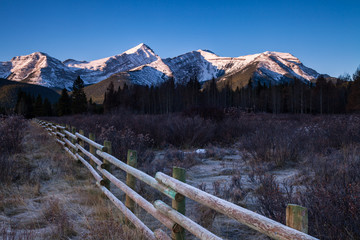 A wooden fence in a meadow in the Canadian Rocky Mountains, Alberta, Canada