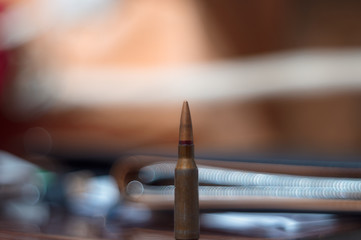 Rifle ammo on blurred background. Close-up view.