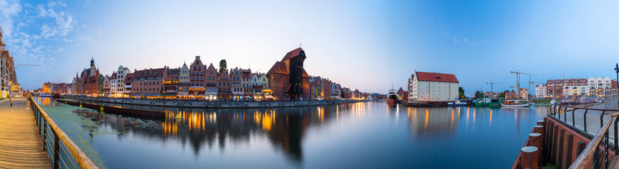 Fototapeta na wymiar Panorama of Gdansk old town reflected in Motlawa river at dusk, Poland