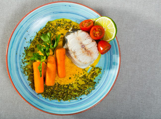 Top view of steamed merluccius with vegetable pate