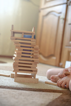 Tower is constructed of wooden toys. Toys, games and child development