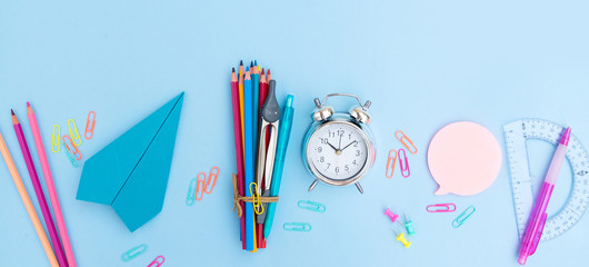 Back to school styled scene with school supplies on blue background banner