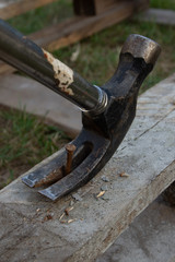 Close up of a claw hammer removing a nail