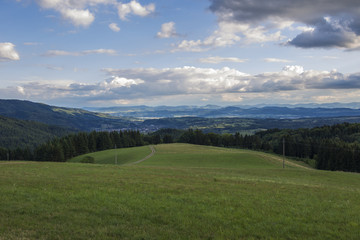 Fototapeta na wymiar Panorama from Sweigmatt in the Black Forest over the city Wehr to the Alps