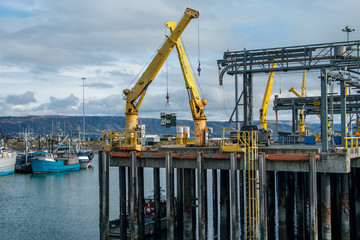 Alaska Shipping Dock:  Large cranes move cargo at a dock in Homer, Alaska.
