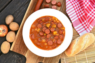 Potato goulash with Debreziner sausage or German name is Kartoffelgulasch mit Debreziner on wooden...