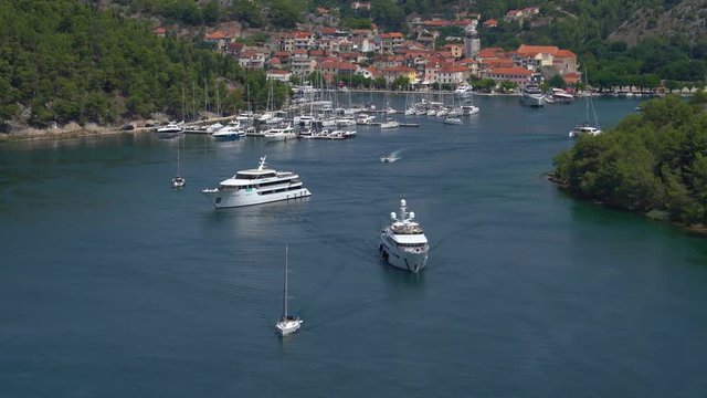 Adriatic sea marina, luxury yacht sailing out.