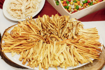 salty smoked cheese on wooden desk on table, wedding reception. beer bar and snacks. catering in restaurant