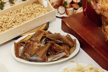 salty smoked fish on wooden desk on table, wedding reception. beer bar and snacks. catering in restaurant