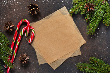 New Year card. Christmas tree with cones and candies on a brown background with space under the text.