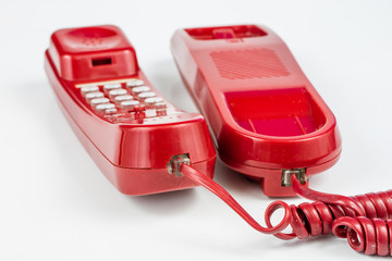 Old red phone with a handset. A telephone set from the nineties.
