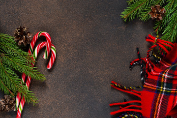 New Year card. Christmas tree with cones and candies on a brown background with space under the text.