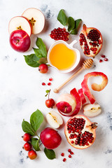 Apple, pomegranate and honey, traditional food of jewish New Year - Rosh Hashana. Copy space background