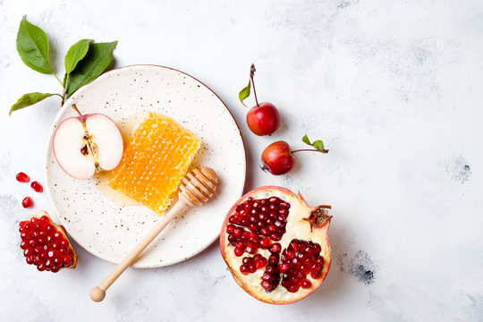 Apple, pomegranate and honey, traditional food of jewish New Year - Rosh Hashana. Copy space background