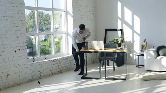 angry businessman in modern office talking and then throwing his mobile phone on the floor swearing crushing smartphone after a phone call businesspeople disagreement stress business conflict quarrel
