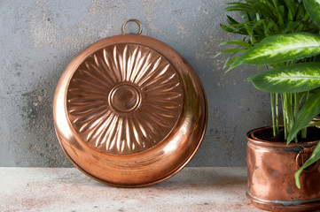 Vintage copper mold on a concrete background.