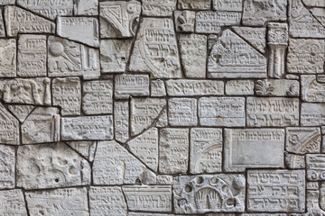 Fragments of jewish tombstones on a wall in the jewish cemetery in Krakow