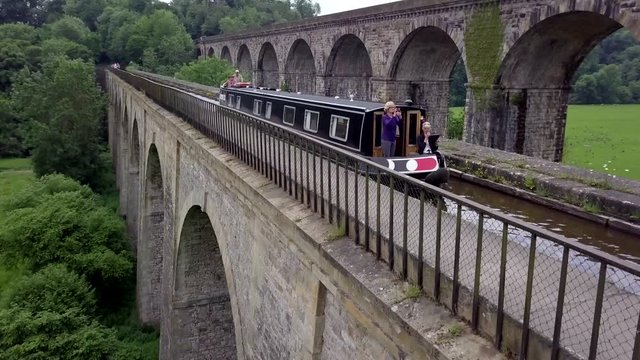 Drone rising to reveal a canal boat on Chirk Aqueduct on the English and Welsh border - 20 second Version