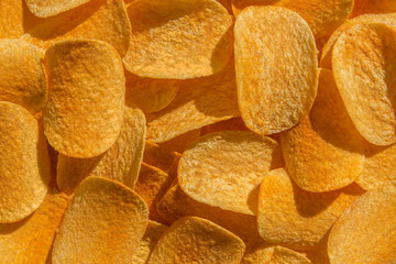Handful of yellow potato chips
