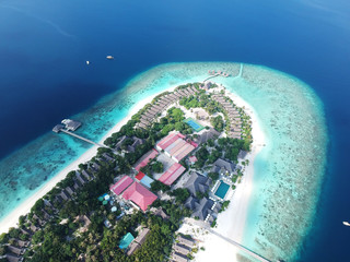 Drone aerial view set of a paradise island resort in maldives.