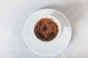 Coffee cup and saucer on a white background.