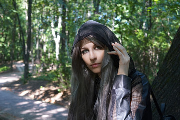 Fototapeta premium Portrait of Girl wear hood in park