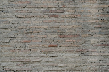 Ancient gray scratched brick wall in Spain