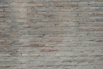 Gray scratched brick wall in Spain. Texture of bricks 