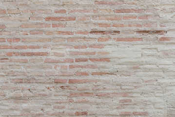 Gray and red scratched brick wall in Spain. Texture of bricks 