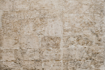 Ancient yellow scratched brick wall in Spain. Texture of bricks 