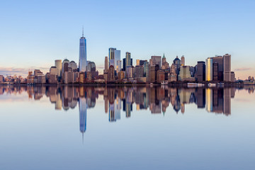 Fototapeta na wymiar Financial District with One World Trade Center and the surrounding buildings in the Lower Manhattan, view from a boat with clear reflection in the water, Manhattan skyline, New York City, USA