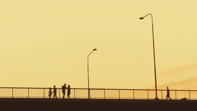 A Couple Standing On A Bridge And People Walking By In The Lovely Sunset Of Stockholm, Sweden. Filmed in SLOW MOTION.