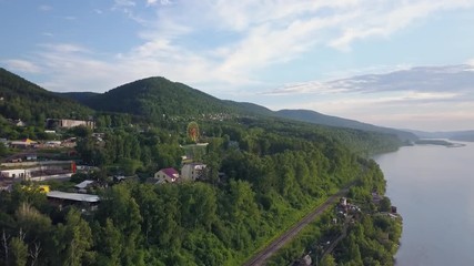 Aerial view of riverbank at Yenisei river Krasnoyarsk city sunrise drone footage