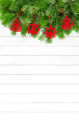 Fototapeta na wymiar Christmas tree branches red decoration white wooden background