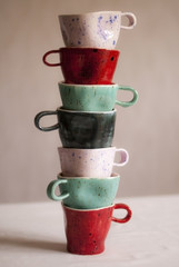 vertical pyramid of colored mugs