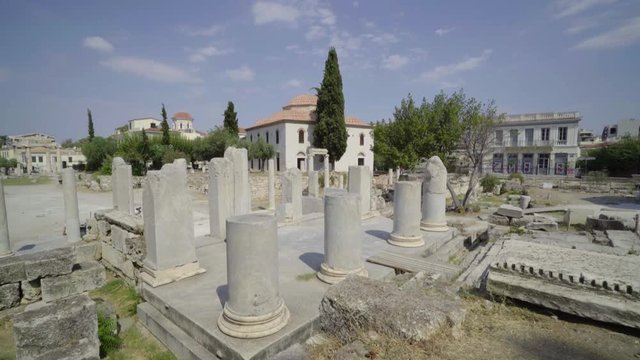 Long Panning shot of Tourists exploring the Roman Agora of Athens Ruins during a quiet afternoon