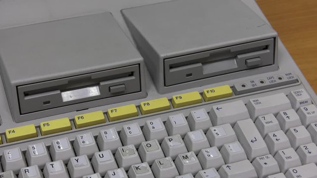 White computer keyboard. Computer or game console from the 90s. Old retro style. , Panning, closeup. 