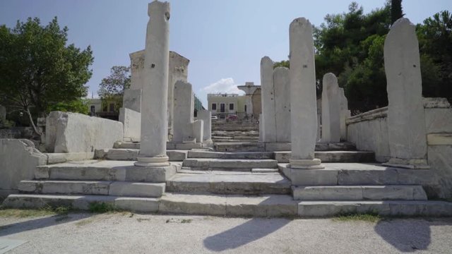 Gimbal walkthrough of Roman Agora Stone Pillars during a sunny day towards the Tower of the Winds