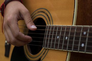 Fototapeta premium soft focus music instrument hobby concept of female right hand with long nails on acoustic guitar strings 