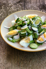 Dietary salad with chicken eggs, green onions, cucumbers and yogurt, salad with fresh vegetables on a plate, vegetarian. Healthy food. Vegetable Salad.