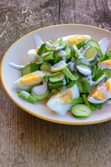 Dietary salad with chicken eggs, green onions, cucumbers and yogurt