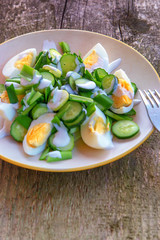 Dietary salad with chicken eggs, green onions, cucumbers and yogurt