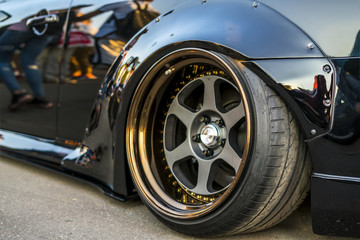 a close up fast deluxe muscle car big wheel