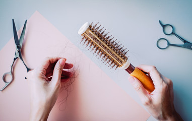 hair fall and lost alopecia woman problem on the comb.