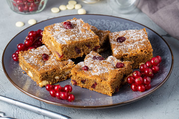 Chocolate Chip Blondies Cut Into Squares, decorated red currant on plate