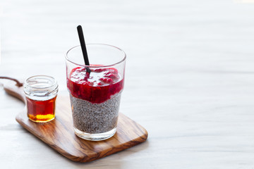 Chia pudding with red berry puree and marple syrup
